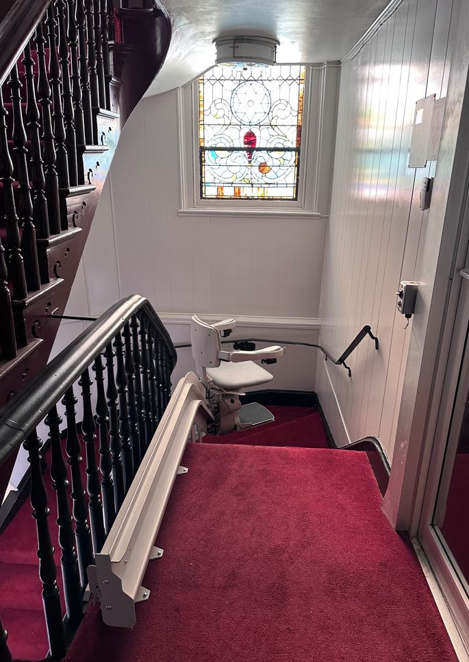 curved Bruno Elite stair lift at top of staircase in church in Maryland