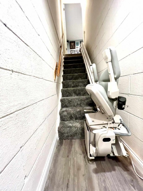 Bruno curved stairlift with components folded up installed by Lifeway Mobility